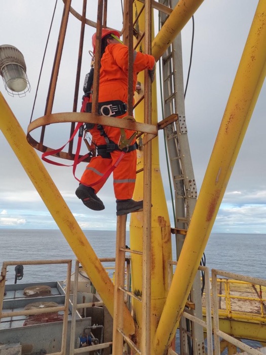 Certified technician working at height on an offshore platform